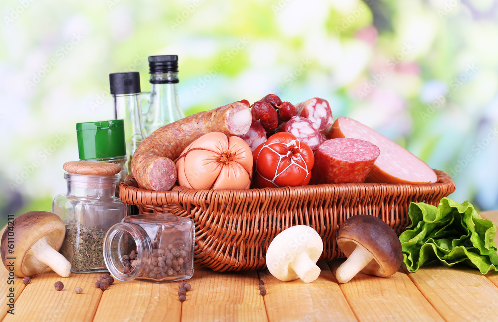 Different sausages on wooden table on natural background