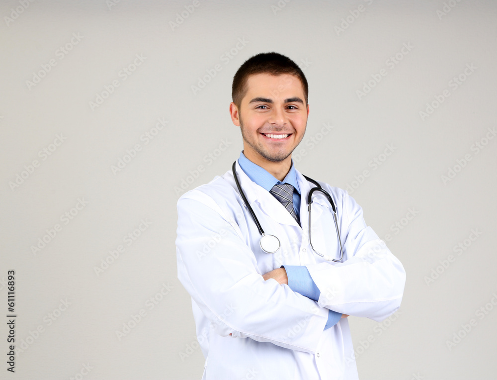 Male Doctor standing  on gray background