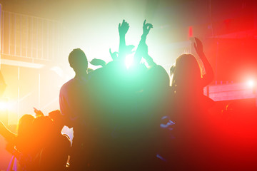 Crowd in front of bright stage lights