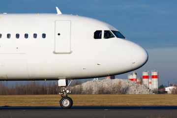 Wall Mural - Detail of white plane nose during taxi on taxiway