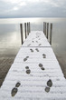 Snow Covered Dock With Human Footprints
