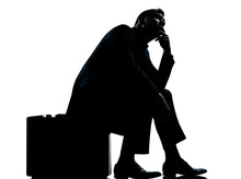 One Business Man Sitting On Suitcase Waiting Silhouette