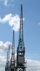 Wall Mural - A Row of Traditional Dockside Cargo Cranes.