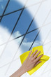 © grufnar - hand cleaning a glass surface of a building