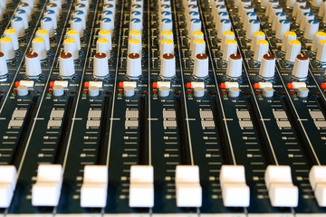 Audio mixer in studio with many buttons