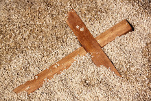 Forgooten Wooden Cross On Sand Texture Background