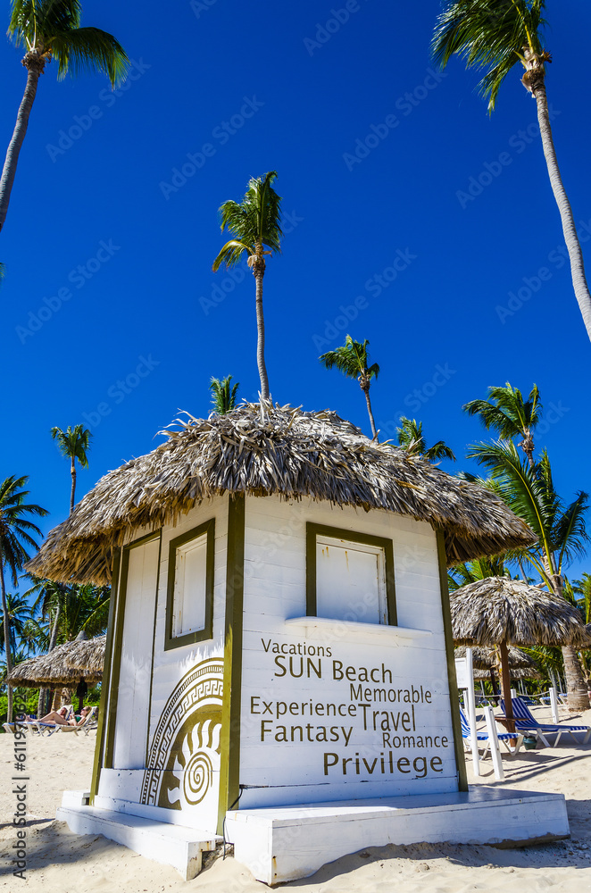 Holidays cottage with a thatched roof on  Dominicana beach - obrazy, fototapety, plakaty 