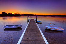 Sunset Moorings And Boat Jetty In A Little Cove Australia