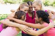 © WavebreakmediaMicro - Participants of breast cancer marathon forming huddle
