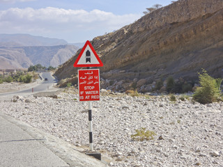 Signposts in Oman - flooded road