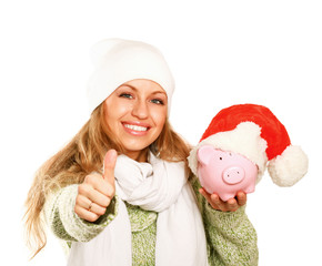 Wall Mural - Young beautiful woman with piggy bank (money box) and showing ok