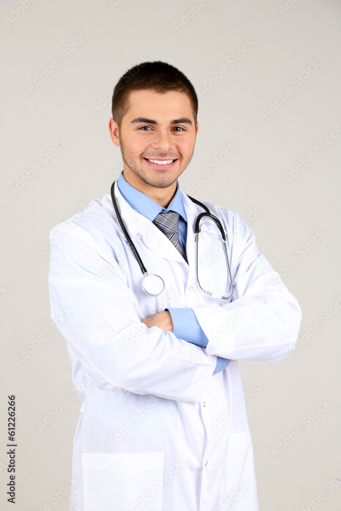Male Doctor standing  on gray background