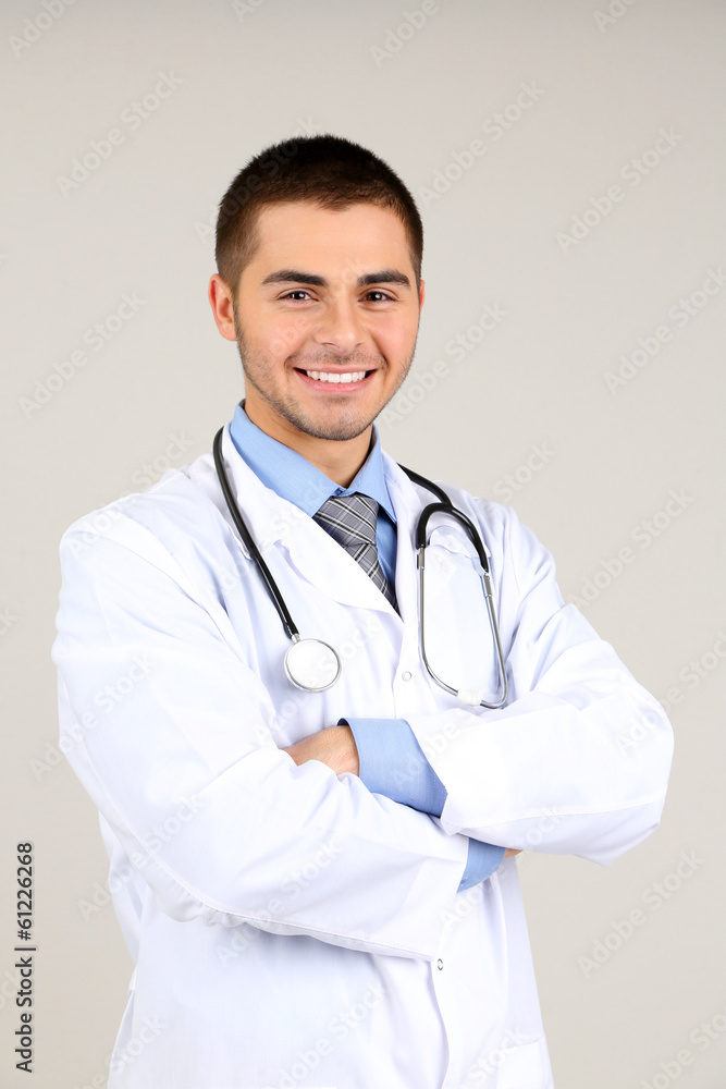 Male Doctor standing  on gray background