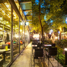 Illuminated Restaurant With Long Footpath