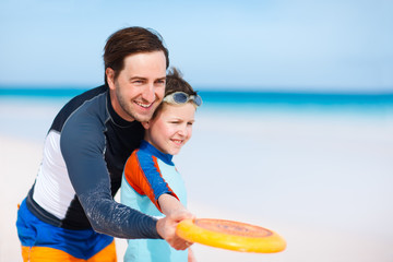 Canvas Print - Father and son playing frisbee