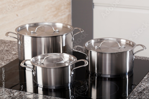 Fotomural New cookware set on induction hob