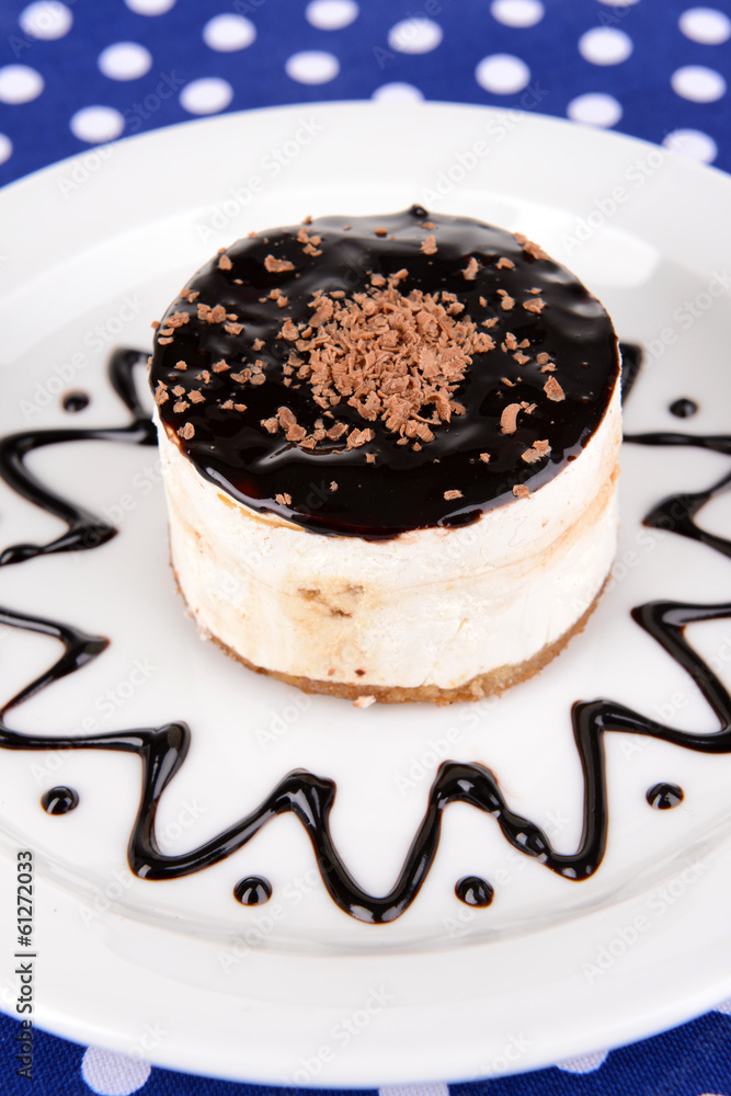 Sweet cake with chocolate on plate on table close-up