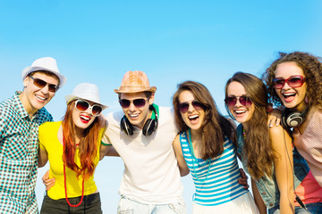 Wall Mural - group of young people wearing sunglasses and hat