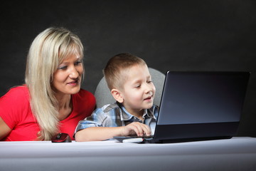 mother with son looking on the laptop