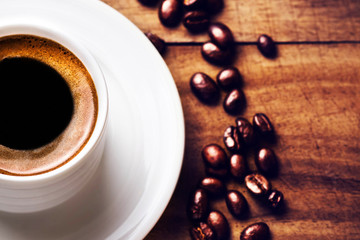Poster - Coffee cup with coffee beans  on wooden background with copyspac