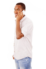 Smiling young man talking on mobile phone, isolated on white bac