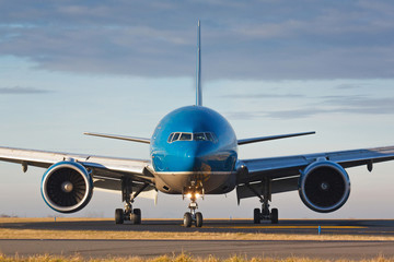 Wall Mural - Eye to eye view with huge taxiing plane