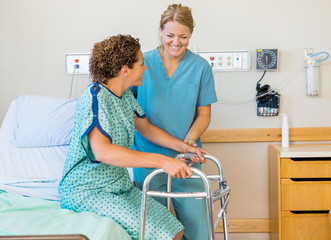 Wall Mural - Nurse Assisting Patient Using Walking Frame In Hospital