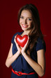 © Africa Studio - Attractive woman with heart, on red background