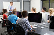 © micromonkey - Group Of Students With Male Tutor In Computer Class