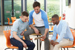 © micromonkey - Three Male Students Looking At Digital Tablet In Classroom