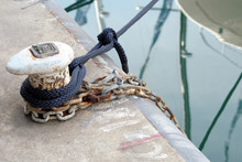Bollard On A Quay With Mooring Ropes