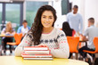 © micromonkey - Female Teenage Student In Classroom With Books