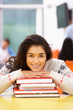 © micromonkey - Female Teenage Student In Classroom With Books