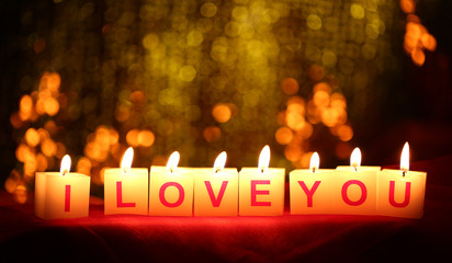 Candles with printed sign I LOVE YOU,on  blur lights background