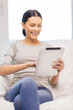 © Syda Productions - smiling woman with tablet pc computer at home