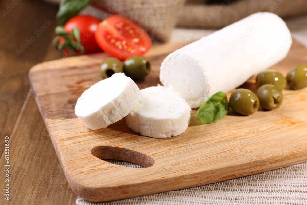 Tasty bushe cheese with tomatoes, olives and basil,