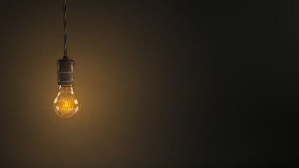 Vintage hanging light bulb over dark background