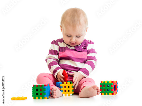 Cute little child is playing with toys