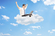 © Ljupco Smokovski - Businessman working on laptop and seated on cloud