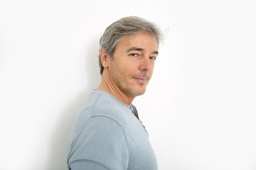 Wall Mural - Mature handsome man standing on white background