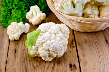 Cauliflower with a basket on the board