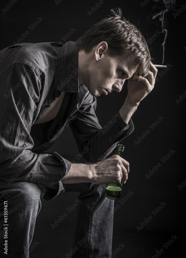 cigarette smoking depression Depressed man thinking over his problems with smoking cigarette Stock Photo