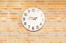 An Old Station Clock Over Bricks Wall