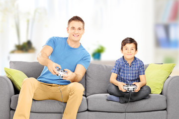 Sticker - Young man playing video game with his younger cousin