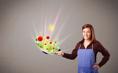 Wall Mural - Young woman cooking fresh vegetables