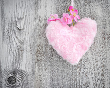 Fur Pink Heart With A Pink Flowers On Wooden Background