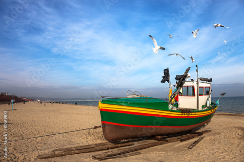Fototapeta na wymiar Fishing boat on the beach in Sopot, Poland.