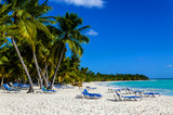 Fototapeta Fototapety z morzem do Twojej sypialni - Exotic vacation in Dominican Republic. Palm trees, beach chairs