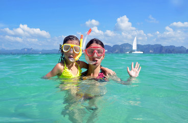 Wall Mural - Happy mother and kid snorkeling in tropical sea, family vacation