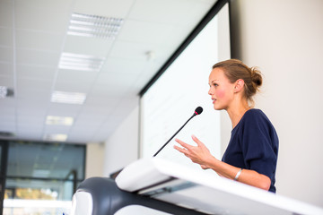 pretty, young business woman giving a presentation